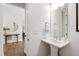 Elegant powder room featuring a pedestal sink and decorative mirror at 1928 Vandiver Way, Apex, NC 27523