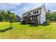 Stunning rear exterior showcasing a spacious yard, deck, screened porch, and an inviting outdoor living space at 1928 Vandiver Way, Apex, NC 27523