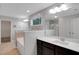Bathroom featuring double sinks, dark wood cabinetry, and a separate tub and shower at 20 Sugarpine Trl, Clayton, NC 27520