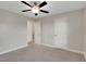 Spacious bedroom with neutral walls, carpeted floors and multiple doors at 20 Sugarpine Trl, Clayton, NC 27520