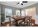 Elegant dining room with hardwood floors, large windows, and a ceiling fan at 20 Sugarpine Trl, Clayton, NC 27520