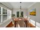 Bright dining room featuring a wooden table, seating for six, and beautiful natural light from a large window at 20 Sugarpine Trl, Clayton, NC 27520