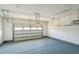 Clean and spacious garage with painted floor and ample storage racks at 20 Sugarpine Trl, Clayton, NC 27520