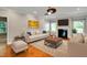 Cozy living room with a fireplace, plush seating, and a ceiling fan at 20 Sugarpine Trl, Clayton, NC 27520