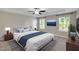 Main bedroom with a large bed and blue accents, complemented by bright natural light and decor at 20 Sugarpine Trl, Clayton, NC 27520