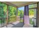 Enclosed back porch with screens and an exterior view of mature trees, offering outdoor living at 20 Sugarpine Trl, Clayton, NC 27520