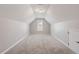Finished attic with carpeted floor, window and door, offering a flexible bonus space at 202 Verrazano Pl, Clayton, NC 27520