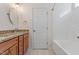 Well-lit bathroom includes vanity, shower and tub combination with white tile at 202 Verrazano Pl, Clayton, NC 27520