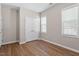 This bedroom has wood floors, neutral walls, and lots of natural light from two windows at 202 Verrazano Pl, Clayton, NC 27520