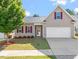 Inviting single-Gathering home with a manicured lawn, attached garage, and appealing architectural details and trim at 202 Verrazano Pl, Clayton, NC 27520
