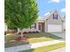 Charming home with a well-manicured lawn, tree, and neutral siding at 202 Verrazano Pl, Clayton, NC 27520