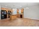 Eat-in kitchen with wooden cabinets, granite countertops, and black appliances at 202 Verrazano Pl, Clayton, NC 27520