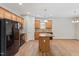 Spacious eat-in kitchen with wooden cabinets, black appliances and hardwood floors at 202 Verrazano Pl, Clayton, NC 27520