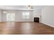 Bright living room with fireplace, fan, and hardwood flooring at 202 Verrazano Pl, Clayton, NC 27520