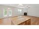 Open concept kitchen flows into living room with fireplace and glass patio doors at 202 Verrazano Pl, Clayton, NC 27520