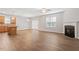 Open-concept living room with fireplace, ceiling fan, and hardwood floors at 202 Verrazano Pl, Clayton, NC 27520