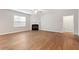 Light-filled living room featuring hardwood floors and a cozy fireplace at 202 Verrazano Pl, Clayton, NC 27520