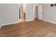 Open main bedroom features hardwood floors and doorways to bath and closet at 202 Verrazano Pl, Clayton, NC 27520