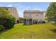 Well-manicured backyard with a lush lawn, patio, grill, and screened-in porch at 2040 Persimmon Ridge Dr, Raleigh, NC 27604