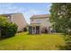 A beautiful backyard with a lush lawn, patio, grill, and screened-in porch at 2040 Persimmon Ridge Dr, Raleigh, NC 27604