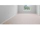 Clean and carpeted bedroom features neutral paint and a large window to maximize light at 2040 Persimmon Ridge Dr, Raleigh, NC 27604