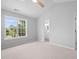 Bright bedroom featuring a vaulted ceiling, large windows, and access to the ensuite bathroom at 2040 Persimmon Ridge Dr, Raleigh, NC 27604