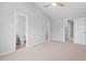 Bright bedroom featuring ensuite bathroom, ceiling fan, neutral walls, and plush carpet at 2040 Persimmon Ridge Dr, Raleigh, NC 27604