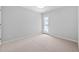 Bright bedroom featuring neutral carpet and a door leading to a private balcony at 2040 Persimmon Ridge Dr, Raleigh, NC 27604