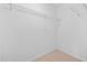 Walk-in closet offers ample storage space with wire shelving and neutral carpeting at 2040 Persimmon Ridge Dr, Raleigh, NC 27604