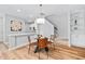 Dining area features a modern light fixture, seating for four, and access to an open kitchen at 2040 Persimmon Ridge Dr, Raleigh, NC 27604