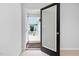 Open doorway provides access to a charming porch with white railings and a neighborhood view at 2040 Persimmon Ridge Dr, Raleigh, NC 27604