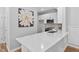 This open kitchen features white cabinets, stainless appliances, light backsplash, and a large island at 2040 Persimmon Ridge Dr, Raleigh, NC 27604