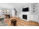 Bright living room features a fireplace, built-in shelving, and a dining area with light wood flooring at 2040 Persimmon Ridge Dr, Raleigh, NC 27604
