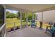 Inviting screened-in porch with a comfortable chair overlooking the well maintained lawn at 2040 Persimmon Ridge Dr, Raleigh, NC 27604