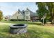 Exterior showcasing well maintained yard, stone patio, grill and fire pit at 2100 Stone Pasture Rd, Fuquay Varina, NC 27526