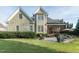Well-maintained backyard features a lush lawn, stone patio, and screened-in porch at 2100 Stone Pasture Rd, Fuquay Varina, NC 27526