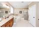 Bathroom with dual sinks and wooden cabinetry, a soaking tub and walk-in shower at 2100 Stone Pasture Rd, Fuquay Varina, NC 27526