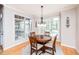 Sun-lit breakfast nook features a round wooden table, comfortable seating, and bright windows at 2100 Stone Pasture Rd, Fuquay Varina, NC 27526