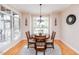 Inviting breakfast nook with natural light from large windows, wood floors, and a modern chandelier at 2100 Stone Pasture Rd, Fuquay Varina, NC 27526