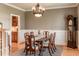 Traditional dining room with wainscoting, a wooden dining table, and chandelier lighting at 2100 Stone Pasture Rd, Fuquay Varina, NC 27526