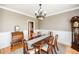 Formal dining room with a large wooden table, wainscoting, and a view into the kitchen at 2100 Stone Pasture Rd, Fuquay Varina, NC 27526