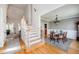 Bright foyer featuring hardwood floors, staircase, and an open view to the dining room at 2100 Stone Pasture Rd, Fuquay Varina, NC 27526
