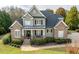 Charming home featuring a stone and siding facade, inviting front porch, and well-manicured lawn at 2100 Stone Pasture Rd, Fuquay Varina, NC 27526