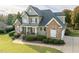 Charming home featuring a stone and siding facade, inviting front porch, and well-manicured lawn at 2100 Stone Pasture Rd, Fuquay Varina, NC 27526
