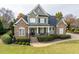 Charming home featuring a stone and siding facade, inviting front porch, and well-manicured lawn at 2100 Stone Pasture Rd, Fuquay Varina, NC 27526