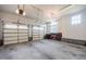 Spacious garage with two large doors and ample overhead storage offers convenience and functionality at 2100 Stone Pasture Rd, Fuquay Varina, NC 27526