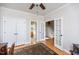 Hallway with hardwood floors offering doorways to a bathroom and staircase to the second floor at 2100 Stone Pasture Rd, Fuquay Varina, NC 27526