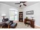 Cozy home office featuring a ceiling fan, an upholstered chair, and a wooden desk with a bookshelf at 2100 Stone Pasture Rd, Fuquay Varina, NC 27526
