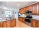Well-lit kitchen featuring granite countertops, stainless steel appliances, and light wood cabinets at 2100 Stone Pasture Rd, Fuquay Varina, NC 27526