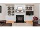 Bright living room with a fireplace, built-in shelving, and hardwood floors at 2100 Stone Pasture Rd, Fuquay Varina, NC 27526
